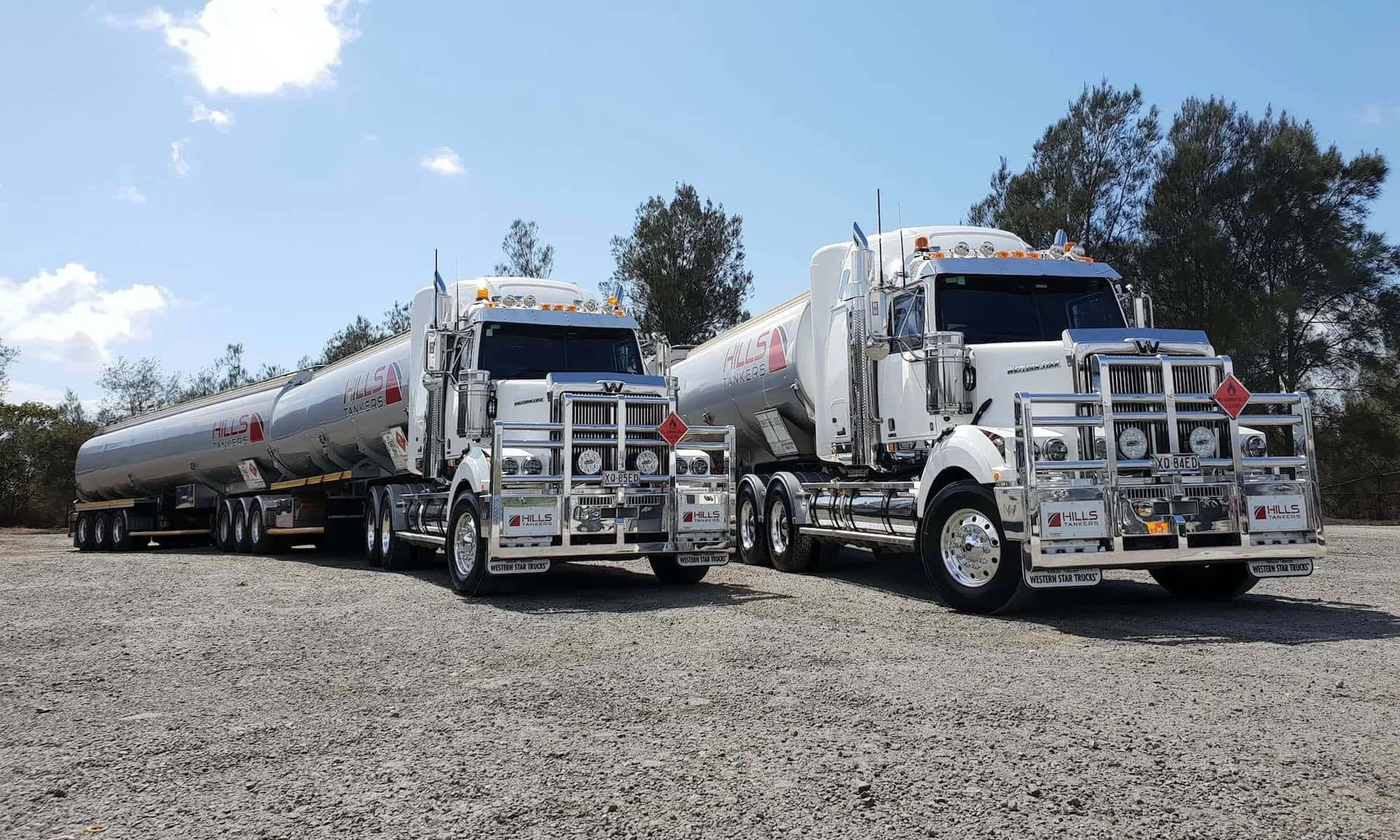 Two Hills Tankers Western Star prime movers with polished tanker trailers parked side by side