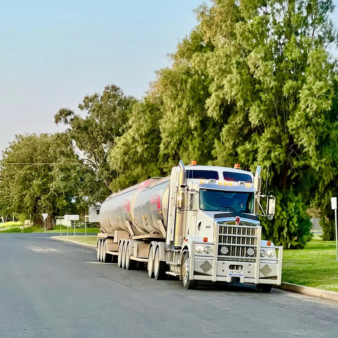 Hills Tankers Kenworth road train pulled up on a quiet tree-lined street in Gunnedah